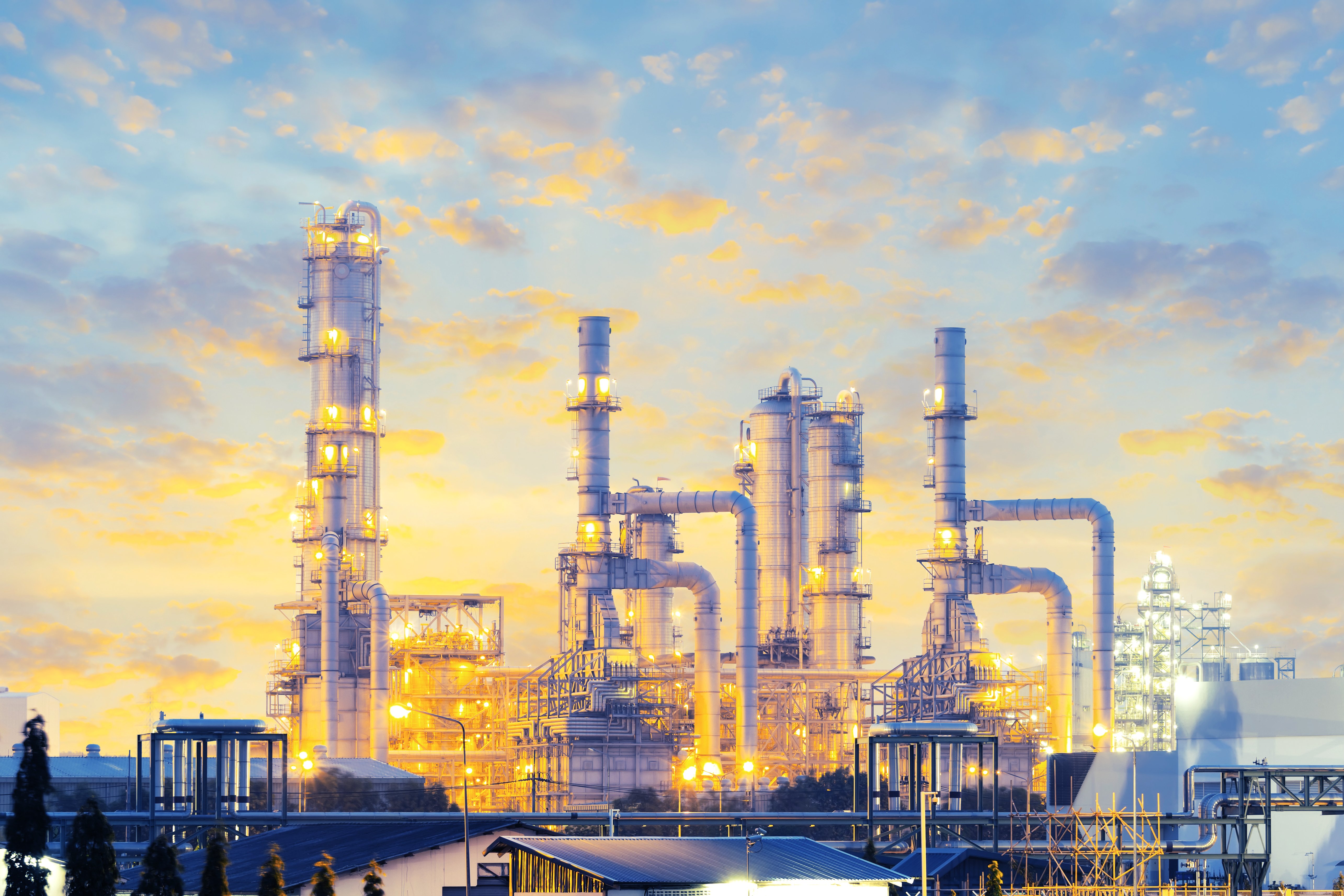 a factory with persony towers and lights