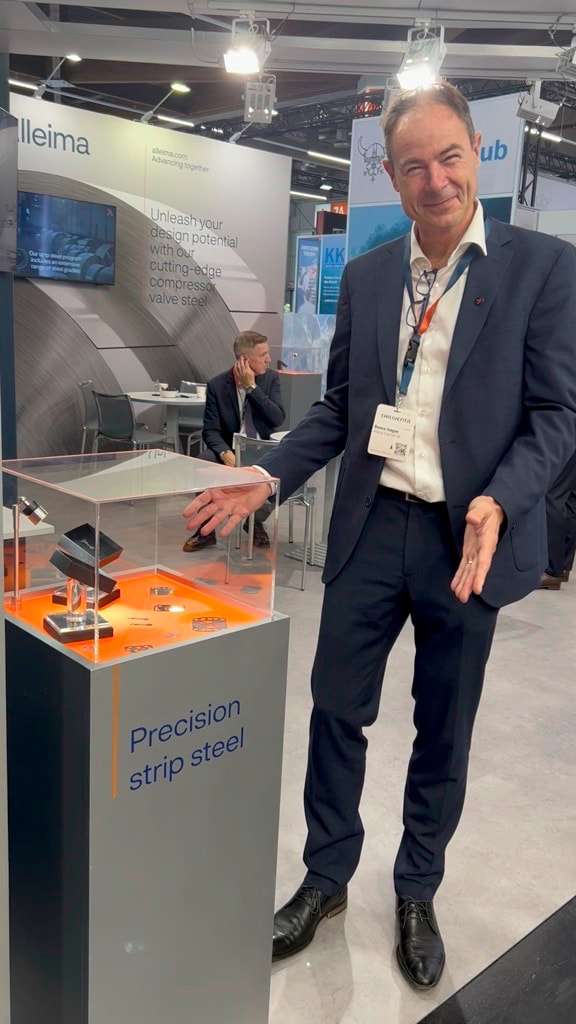 a person in a suit standing in front of a display case