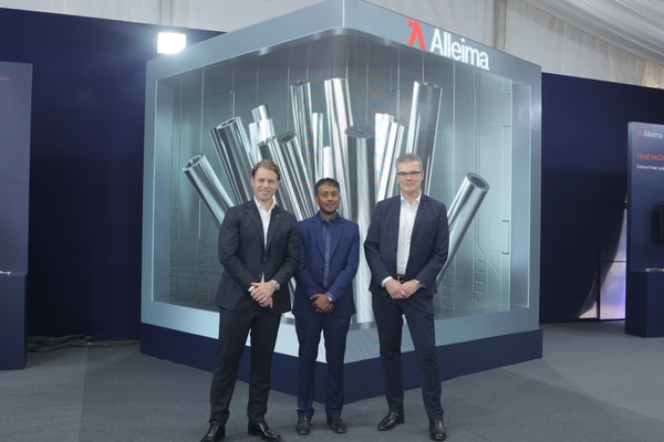 a group of men standing in front of a large display