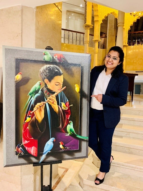 a person standing next to a painting