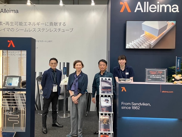 a group of people standing in front of a display