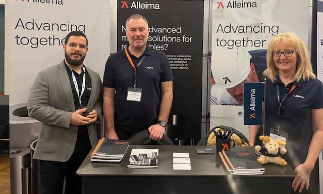 a group of men standing in front of a table