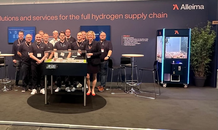 a group of people standing in front of a sign