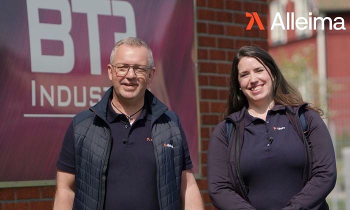 a person and person standing in front of a brick wall
