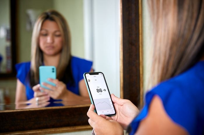 a person holding a phone in front of a mirror