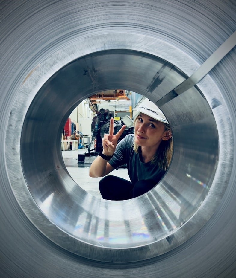 a person in a white helmet holding up a peace sign