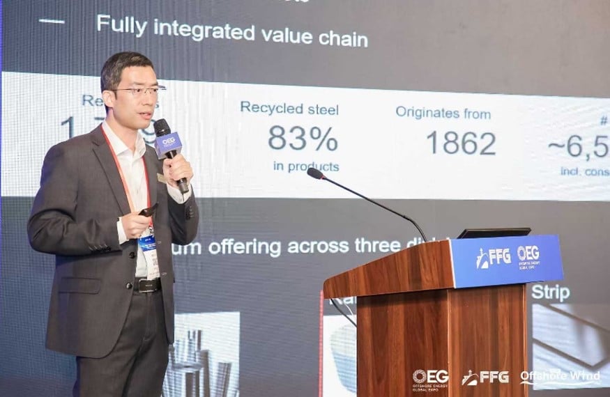 a person standing at a podium speaking into a microphone