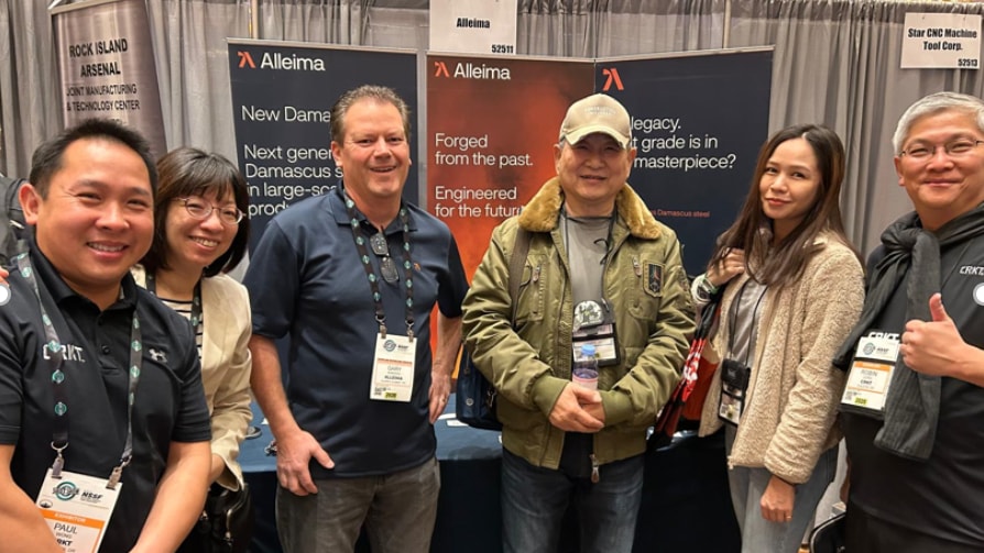 a group of people standing in front of a table
