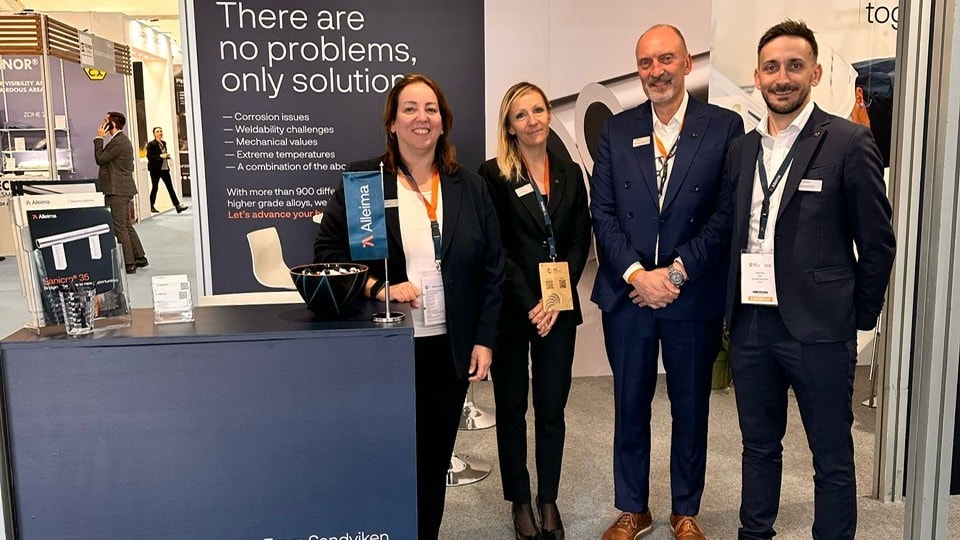 a group of people standing in front of a sign