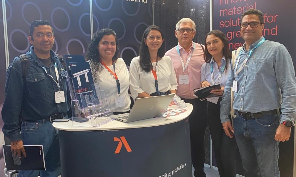 a group of people standing in front of a table